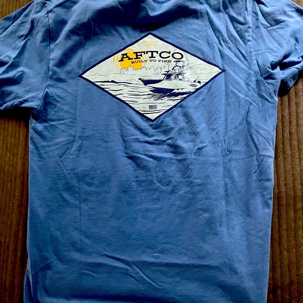 light blue aftico tee with design on the back